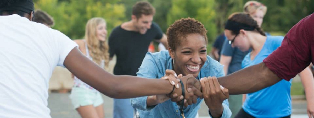 Woman holding hands with two others