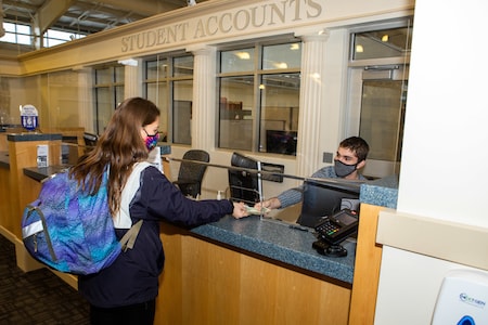 student paying bill to student accounts office