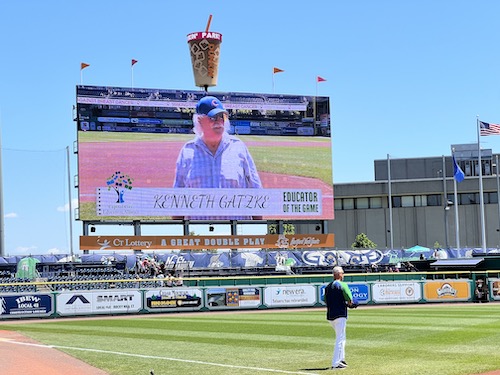 A man standing in the middle of a baseball field