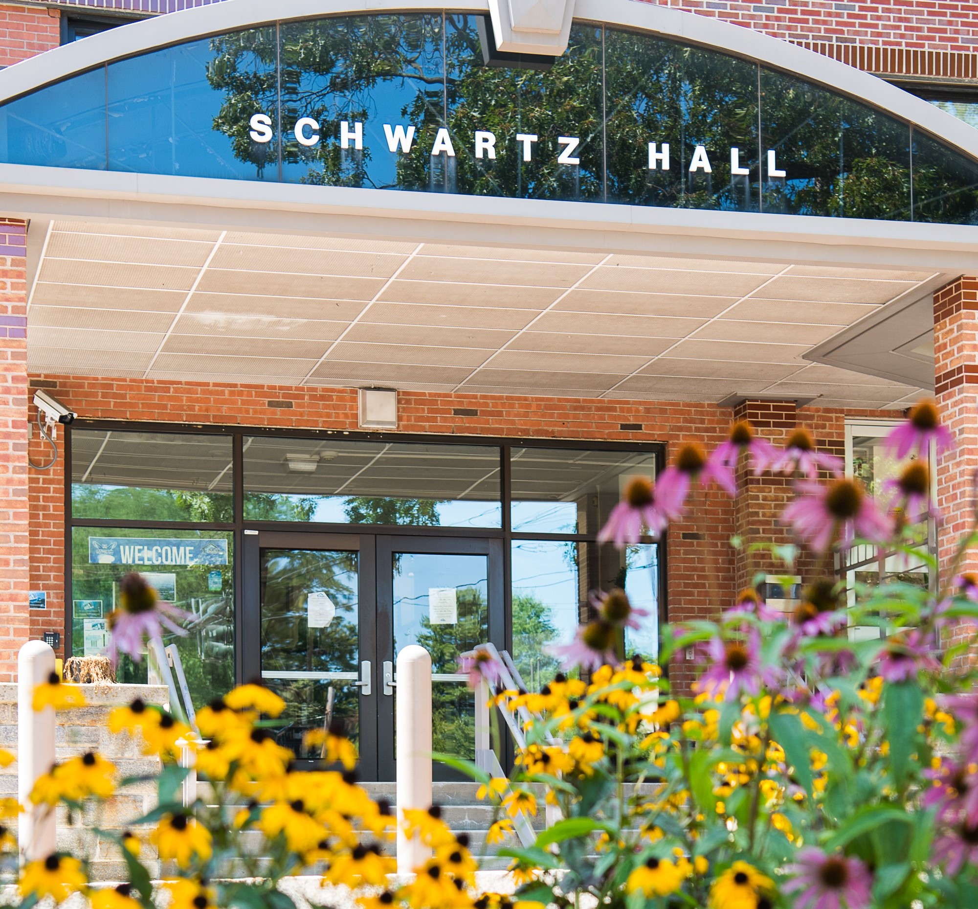 Schwartz Hall with flowers in front of it