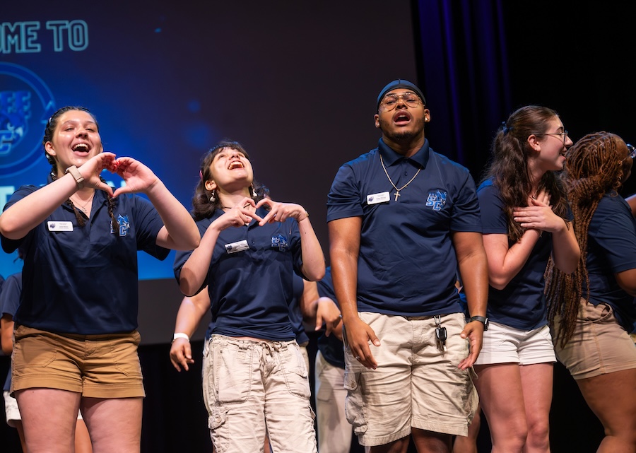 Students performing on stage during orientation