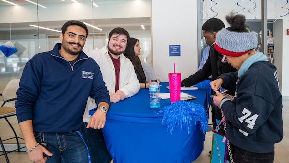 Student standing around a table getting ready for spring session
