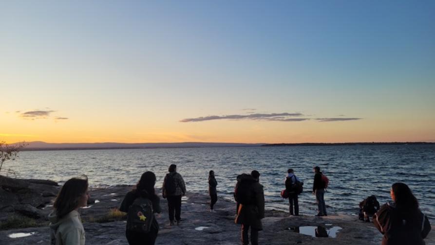 A Group of Earth Science students on a beach at sunset.