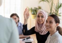 Woman raising her hand with a question