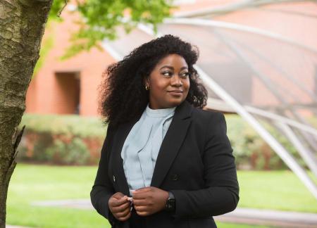 Rose Mutale '21, Interdisciplinary Studies graduate poses outside Engleman Hall