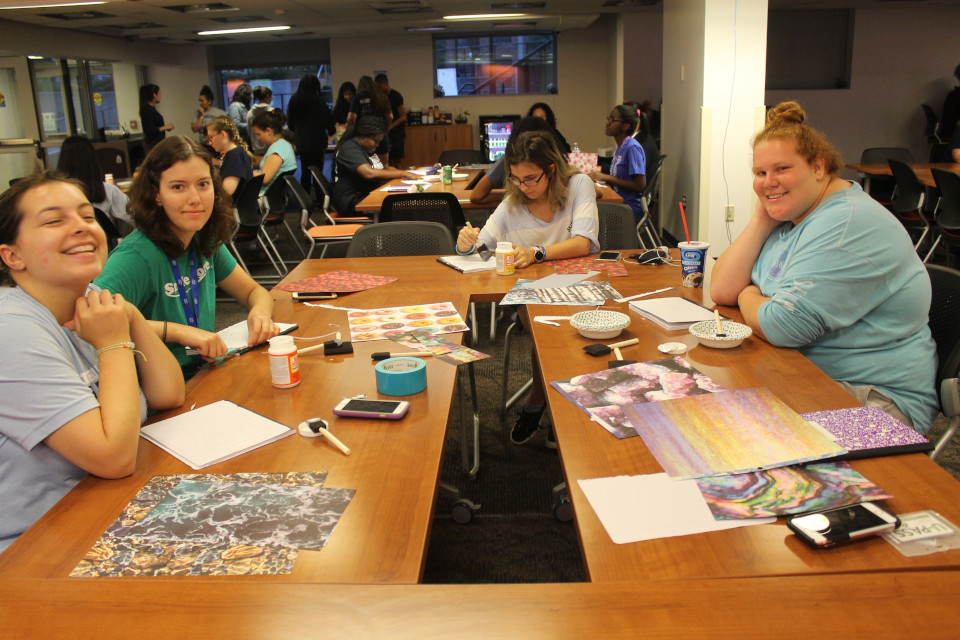 Students playing games around a table