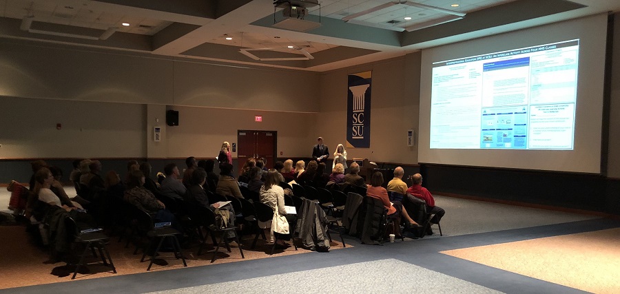 picture of a group of faculty at a presentation