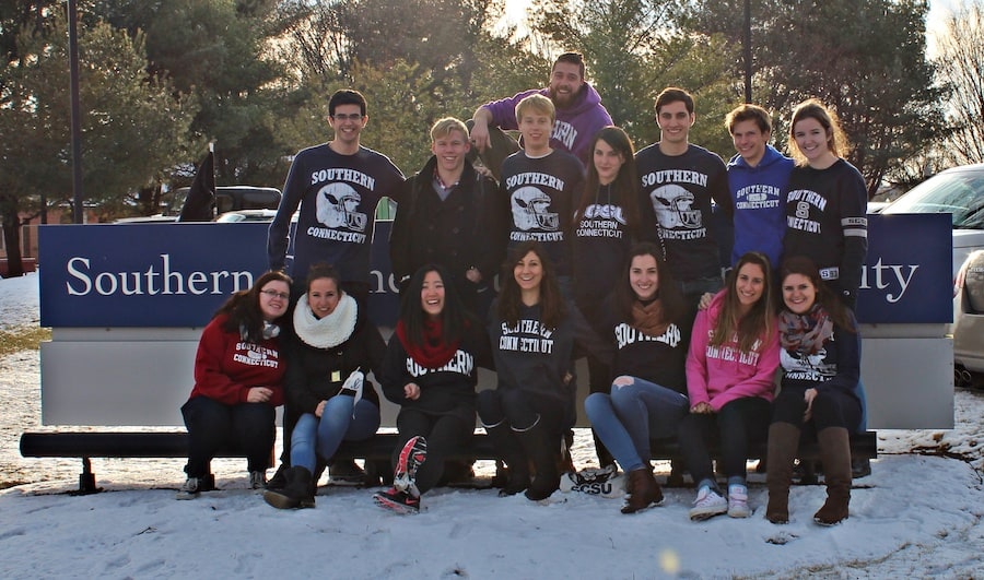 Exchange students in front of SCSU sign