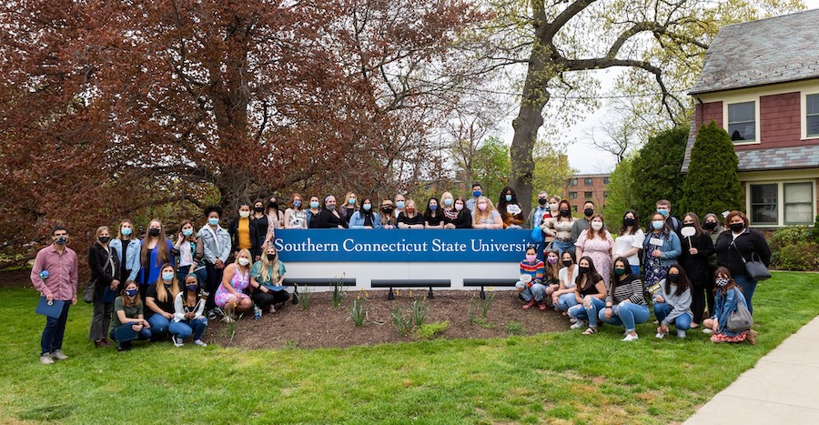Students around the SCSU sign