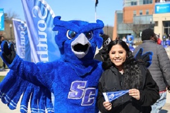 Otus the owl mascot with a student